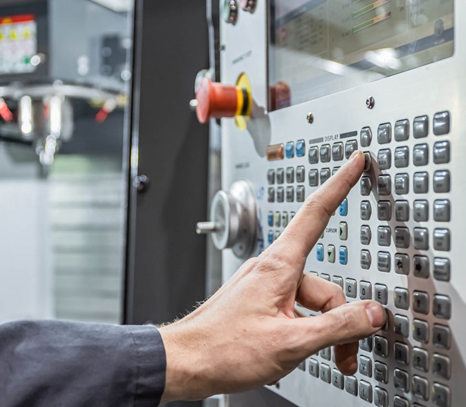 Person programming a CNC machine